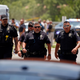 Police walk near Robb Elementary School following a shooting, Tuesday, May 24, 2022, in Uvalde, Texas.